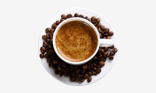 A cup of coffee surrounded by coffee beans